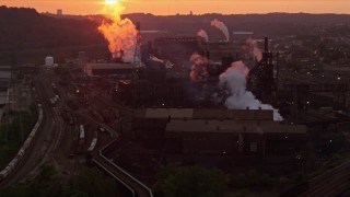 AX108_015E - 4K aerial stock footage of the U.S. Steel Mon Valley Works, Braddock, Pennsylvania, sunset