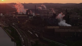 AX108_018 - 4K aerial stock footage flying by U.S. Steel Mon Valley Works, Braddock, Pennsylvania, sunset