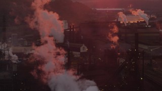 AX108_021 - 4K aerial stock footage of the U.S. Steel Mon Valley Works and smoke stacks, Braddock, Pennsylvania, sunset