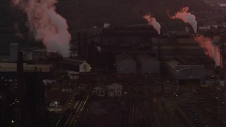 AX108_022 - 4K aerial stock footage passing by U.S. Steel Mon Valley Works buildings, Braddock, Pennsylvania, sunset