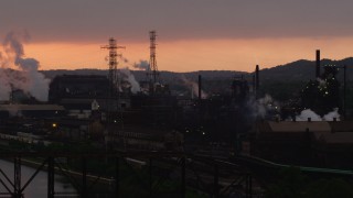 AX108_029 - 4K aerial stock footage of U.S. Steel Mon Valley Works, Braddock, Pennsylvania, sunset