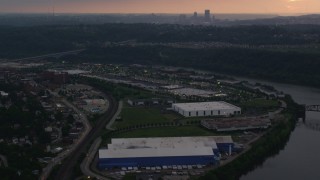 AX108_043 - 4K aerial stock footage of Downtown Pittsburgh seen from warehouses, Munhall, Pennsylvania, twilight