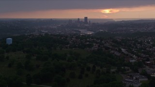 AX108_046E - 4K aerial stock footage of Downtown Pittsburgh skyline from a distance, Pennsylvania, sunset