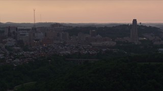 AX108_050E - 4K aerial stock footage of University of Pittsburgh campus, Pennsylvania, sunset