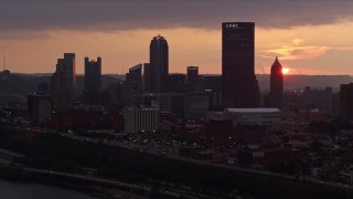 AX108_055E - 4K aerial stock footage of Downtown Pittsburgh skyline from the Monongahela River, Pennsylvania, sunset