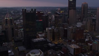 AX108_066E - 4K aerial stock footage of a view of the city's skyscrapers in Downtown Pittsburgh, twilight