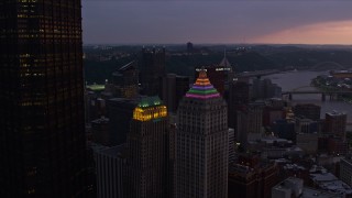 AX108_073E - 4K aerial stock footage flying by Gulf Tower and U.S. Steel Tower, Downtown Pittsburgh, Pennsylvania, twilight