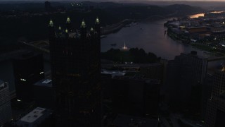 AX108_085 - 4K aerial stock footage flying by PPG Place toward Point State Park, Downtown Pittsburgh, Pennsylvania, twilight