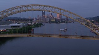 AX108_093E - 4K aerial stock footage of Downtown skyline seen from the West End Bridge, Pittsburgh, Pennsylvania, twilight