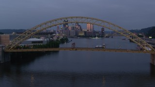AX108_094 - 4K stock footage aerial video flying over West End Bridge toward Downtown Pittsburgh, Pennsylvania, twilight