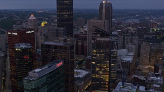 AX108_100E - 4K aerial stock footage flying over skyscrapers, Downtown Pittsburgh, Pennsylvania, twilight