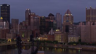 AX108_114E - 4K aerial stock footage of Downtown Pittsburgh skyscrapers from Allegheny River, Pennsylvania, twilight