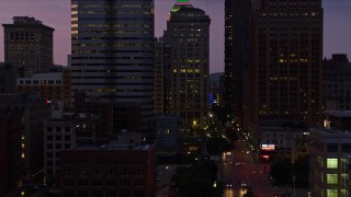 AX108_128E - 4K aerial stock footage of city streets and office buildings, Downtown Pittsburgh, Pennsylvania, twilight