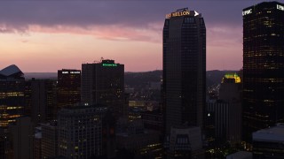 AX108_132E - 4K aerial stock footage flying by the Grant Building, BNY Mellon Center and U.S. Steel Tower, Pittsburgh, twilight