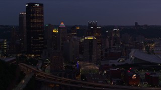 AX108_137E - 4K aerial stock footage skyscrapers in Downtown Pittsburgh, Pennsylvania, twilight