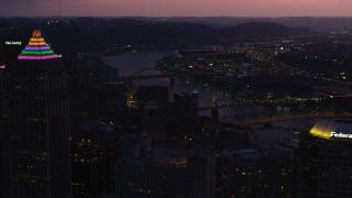 AX108_141 - 4K aerial stock footage of PNC Park, Heinz Field and bridges spanning Allegheny River, Pittsburgh, Pennsylvania, twilight