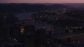 AX108_142 - 4K stock footage aerial video of PNC Park, Heinz Field and Allegheny River, Pittsburgh, Pennsylvania, twilight