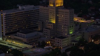 AX108_146E - 4K aerial stock footage approaching Allegheny General Hospital, Pittsburgh, Pennsylvania, night