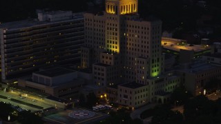 AX108_148 - 4K aerial stock footage flying by Allegheny General Hospital, Pittsburgh, Pennsylvania, night