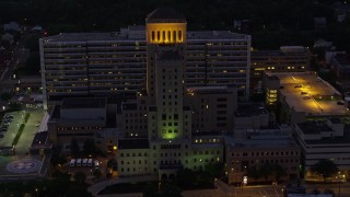 AX108_149 - 4K stock footage aerial video orbiting Allegheny General Hospital, Pittsburgh, Pennsylvania, night