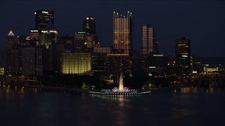 AX108_164E - 4K aerial stock footage of Downtown Pittsburgh skyscrapers and Point State Park; night