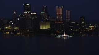 AX108_166 - 4K aerial stock footage of Downtown Pittsburgh skyscrapers and Point State Park, Pennsylvania, night