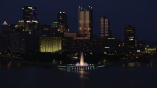 AX108_167 - 4K aerial stock footage approaching Point State Park fountain and Downtown Pittsburgh, night