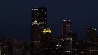 AX108_173 - 4K aerial stock footage of Gulf Tower and U.S. Steel Tower, Pittsburgh, Pennsylvania, night
