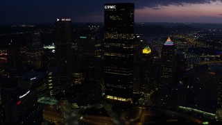 AX108_177E - 4K aerial stock footage of Gulf Tower and U.S. Steel Tower, Pittsburgh, Pennsylvania, twilight
