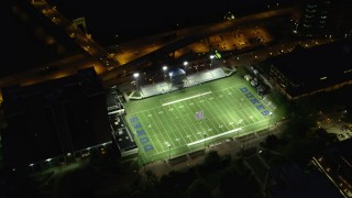 AX108_191 - 4K stock footage aerial video of a bird's eye orbiting Arthur J. Rooney Athletic Field, Pittsburgh, night