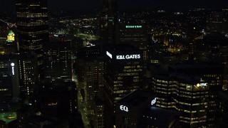 AX108_222E - 4K aerial stock footage flying by skyscrapers, Downtown Pittsburgh, Pennsylvania, night