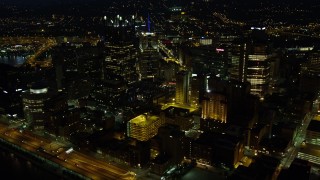 AX108_228E - 4K aerial stock footage flying by office buildings while approaching PPG Place, Downtown Pittsburgh, night