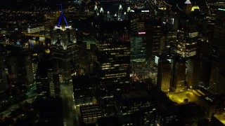 AX108_230E - 4K aerial stock footage flying around PPG Place and Fifth Avenue Place, Downtown Pittsburgh, night