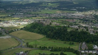 AX109_015E - 5.5K aerial stock footage of flying away from Stirling Castle and residential area, Scotland
