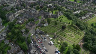 AX109_026E - 5.5K aerial stock footage of a church and cemetery near residential area, Stirling, Scotland