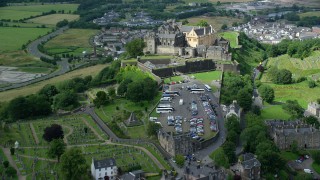 AX109_034 - 5.5K stock footage aerial video fly over church and cemetery, approach Stirling Castle, Scotland