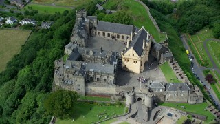 AX109_040 - 5.5K stock footage aerial video orbiting historic Stirling Castle with tourists, Scotland