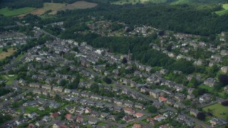 AX109_056E - 5.5K aerial stock footage of a residential neighborhood and trees, Stirling, Scotland