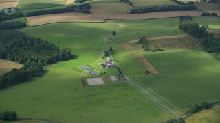 AX109_061E - 5.5K aerial stock footage of flying over a sheep farm, Stirling, Scotland