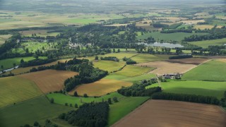 AX109_063E - 5.5K aerial stock footage of farm and farmland, Blair Drummond, Scotland