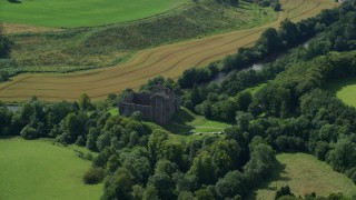 AX109_066E - 5.5K aerial stock footage of orbiting Doune Castle and a river, Scotland