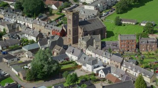 AX109_073 - 5.5K aerial stock footage of church in residential area, Doune Scotland