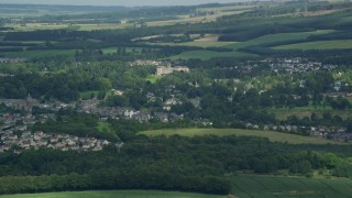 AX109_092E - 5.5K aerial stock footage of small town surrounded by countryside, Dunblane, Scotland