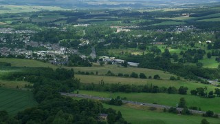 AX109_094 - 5.5K aerial stock footage of a town surrounded by countryside, Dunblane, Scotland