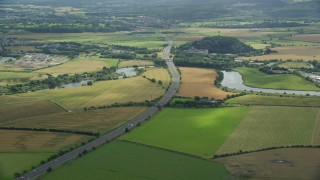 AX109_095E - 5.5K aerial stock footage of M9 highway and farmland in Stirling, Scotland