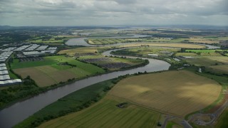 AX109_102E - 5.5K aerial stock footage of River Forth and farmland, Fallin, Scotland