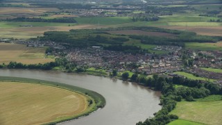 AX109_105E - 5.5K aerial stock footage flyby River Forth and a small village of Fallin, Scotland