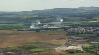 AX109_109 - 5.5K aerial stock footage of a large Factory near Cowie and farmland, Scotland