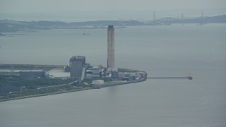 AX109_113 - 5.5K aerial stock footage of a riverfront power plant, Alloa, Scotland