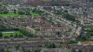 AX109_132E - 5.5K aerial stock footage flyby apartment buildings in Falkirk, Scotland
